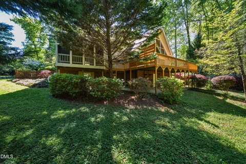 a kitchen with stainless steel appliances granite countertop wooden cabinets a sink and a large window