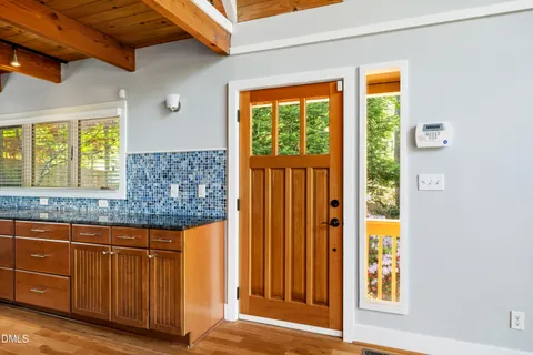 a view of a balcony with wooden floor and fence