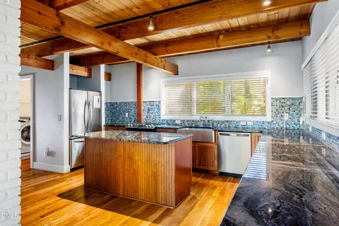 a bathroom with a tub shower sink and toilet