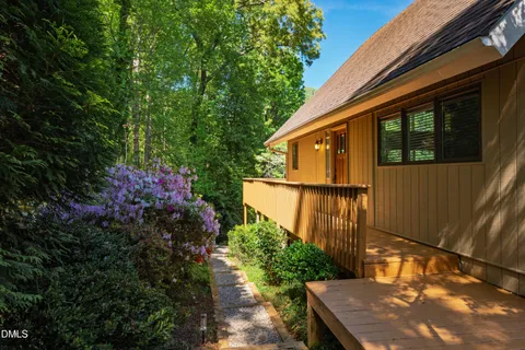 a view of a house with backyard and wooden fence
