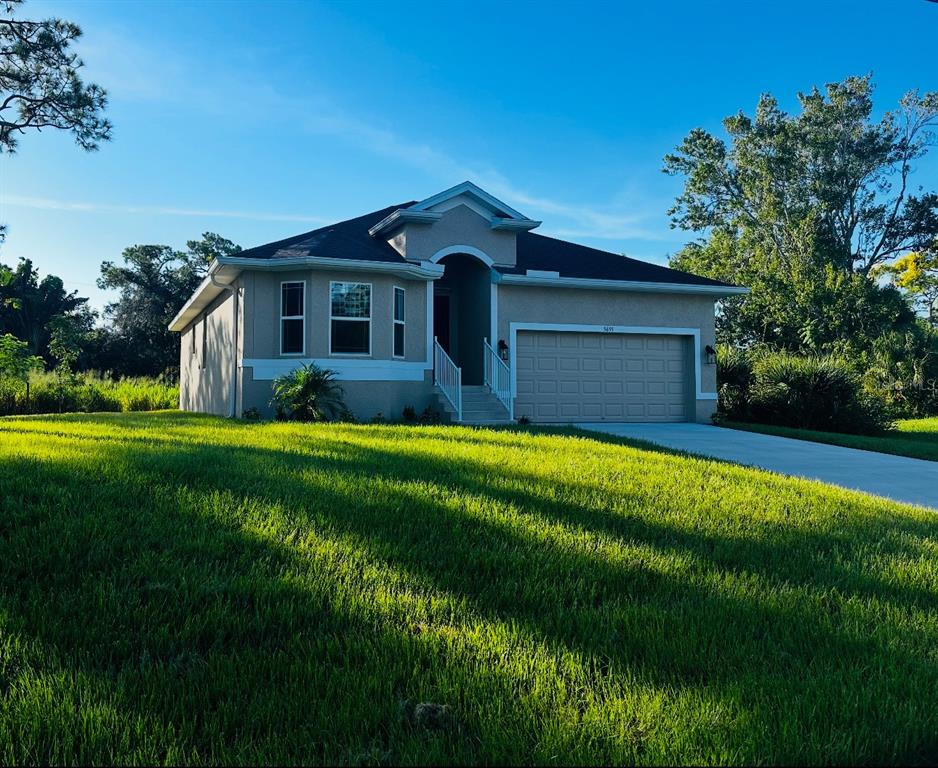 5655 Hale Road Venice, FL 34293 - Photo 1 of 1 a front view of house with yard and green space