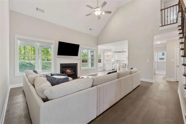 a living room with furniture a fireplace and a flat screen tv
