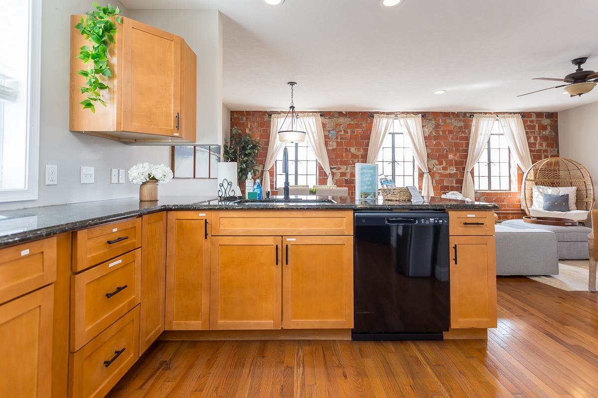 442 First Street Shenandoah, VA 22849 - Photo 18 of 75 a kitchen with stainless steel appliances wooden floors and wooden cabinets