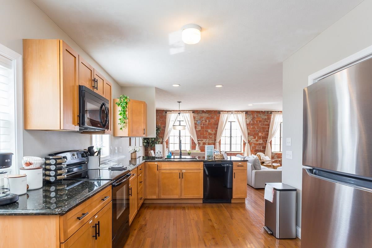 442 First Street Shenandoah, VA 22849 - Photo 25 of 75 a kitchen with a sink a refrigerator a stove cabinets and living room view