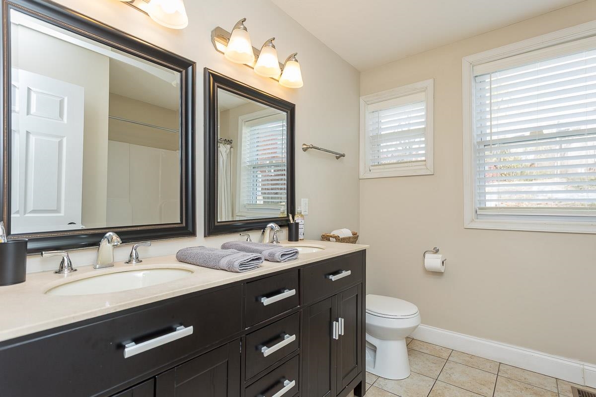 442 First Street Shenandoah, VA 22849 - Photo 41 of 75 a bathroom with a granite countertop sink mirror and a toilet