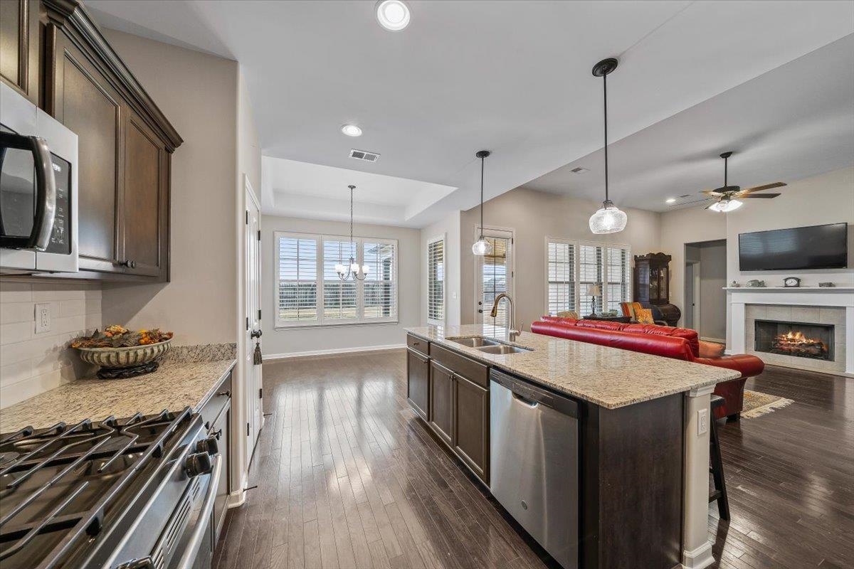 55 Cypress Point Road Oakland, TN 38060 - Photo 30 of 32 a open kitchen with stainless steel appliances granite countertop a stove and a wooden floors