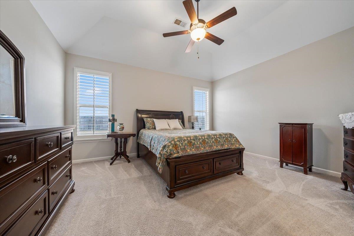 55 Cypress Point Road Oakland, TN 38060 - Photo 13 of 32 a bedroom with a bed and a chandelier