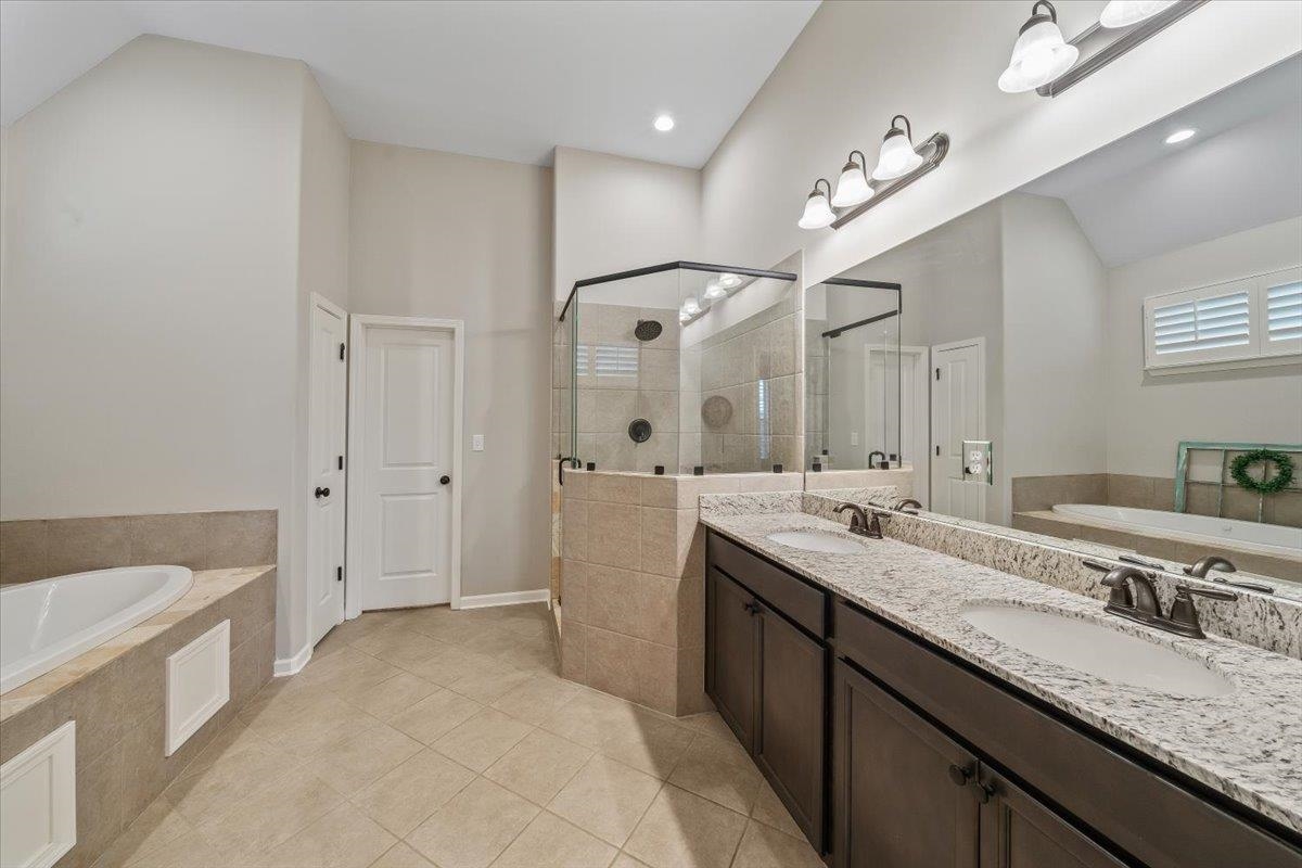 55 Cypress Point Road Oakland, TN 38060 - Photo 14 of 32 a spacious bathroom with a granite countertop sink mirror and a bath tub