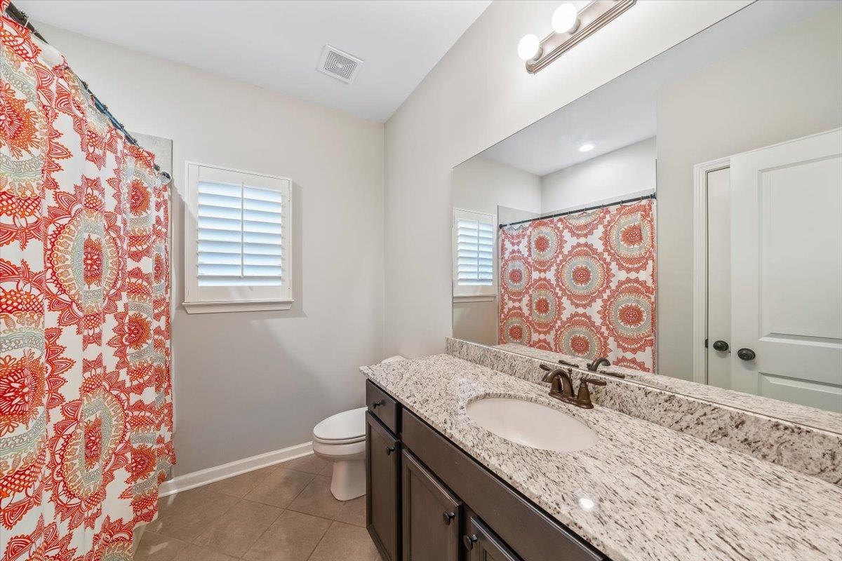55 Cypress Point Road Oakland, TN 38060 - Photo 21 of 32 a bathroom with a granite countertop sink mirror vanity and toilet