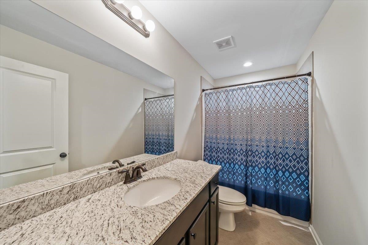 55 Cypress Point Road Oakland, TN 38060 - Photo 23 of 32 a bathroom with a granite countertop sink toilet and shower