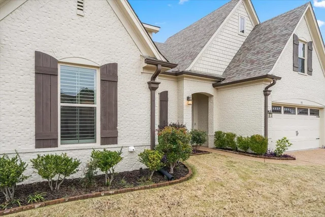 a front view of a house with garden