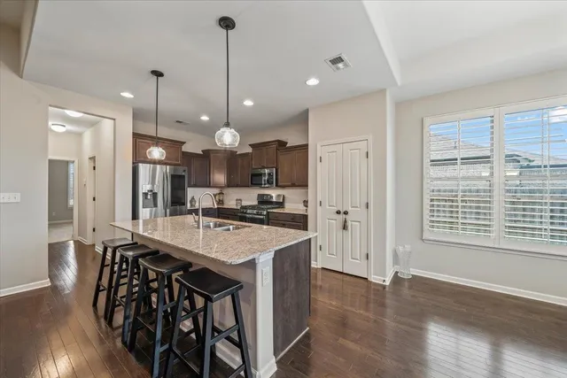 a large kitchen with a table and chairs