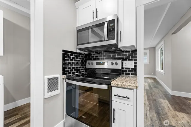 a kitchen with a stove and a microwave