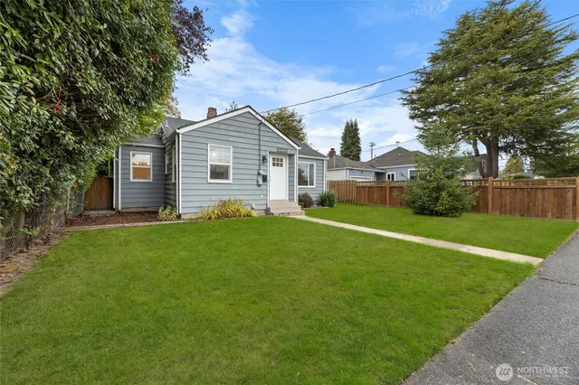 a front view of house with yard and green space