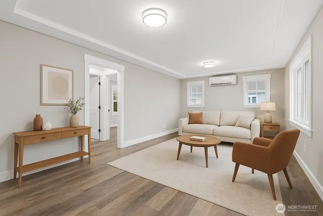 a living room with furniture and a wooden floor