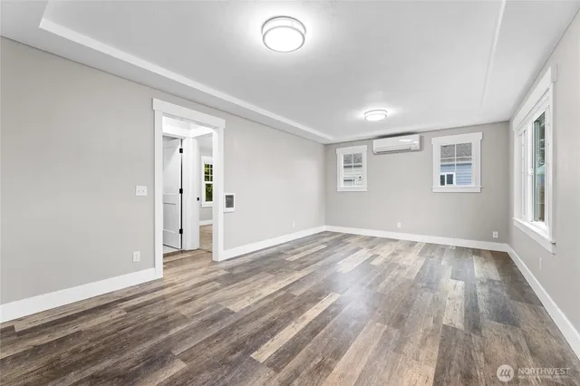 wooden floor in an empty room with a window
