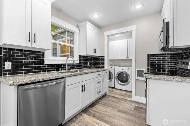 a view of a granite countertop sink and a dishwasher in a kitchen