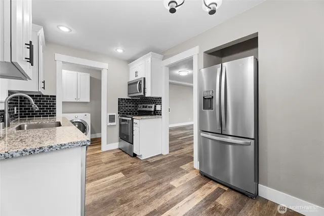 a kitchen with a refrigerator sink and stove