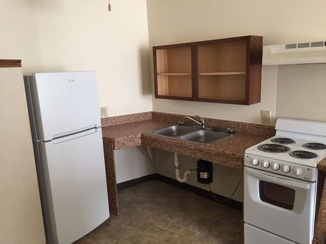 1919 North 11th Street Milwaukee, WI 53205 - Photo 11 of 11 a kitchen with granite countertop a stove and a refrigerator