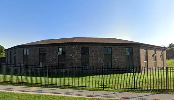 a view of a brick house and a yard