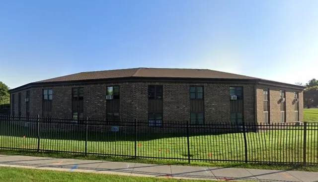 a view of a brick house and a yard