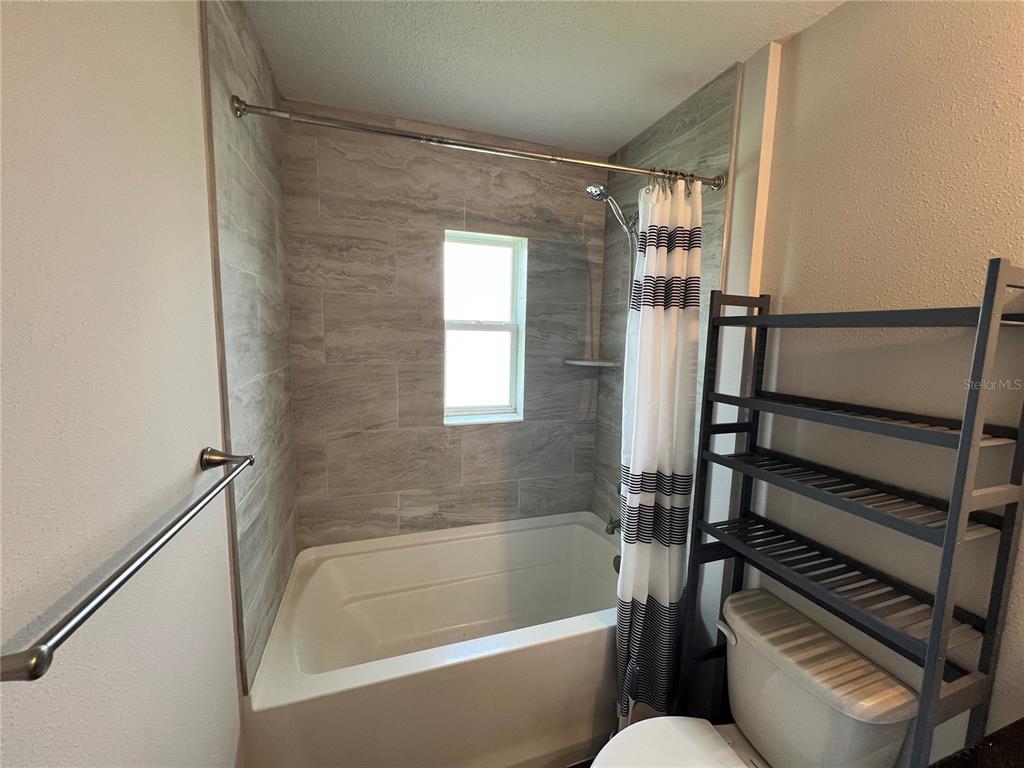 4264 East Taper Street Inverness, FL 34453 - Photo 11 of 29 a bathroom with bathtub and a shower