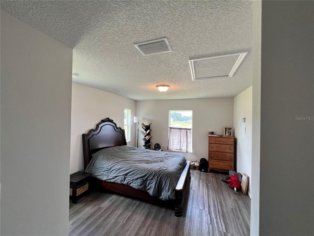 4264 East Taper Street Inverness, FL 34453 - Photo 7 of 29 a bedroom with a bed and wooden floor