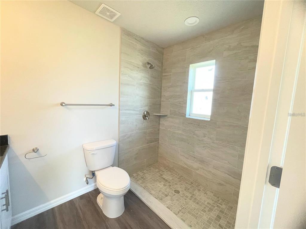 4264 East Taper Street Inverness, FL 34453 - Photo 8 of 29 a bathroom with a toilet a sink and a shower