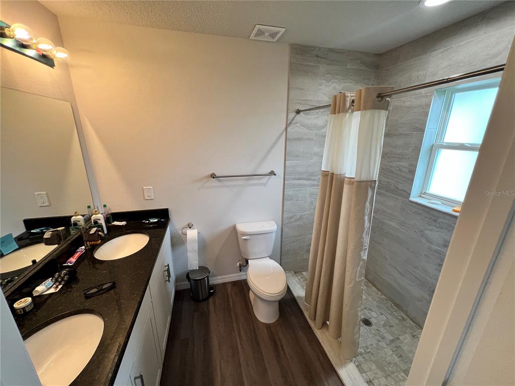 4264 East Taper Street Inverness, FL 34453 - Photo 9 of 29 a bathroom with a sink a toilet a mirror and shower