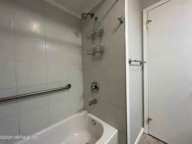 a view of an empty room with wooden floor a fireplace and a window