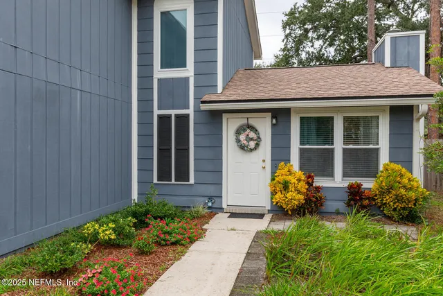 a front view of a house with garden