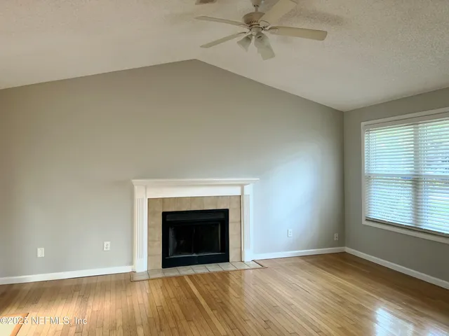 a view of kitchen with wooden floor and electronic appliances