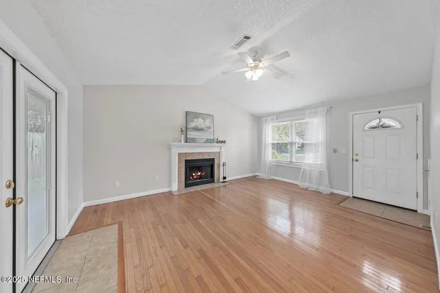 a kitchen with a sink a stove a refrigerator and white cabinets