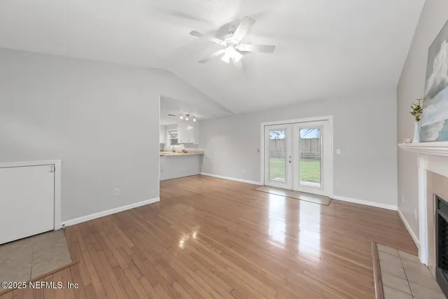 a view of a kitchen sink and dishwasher with wooden floor