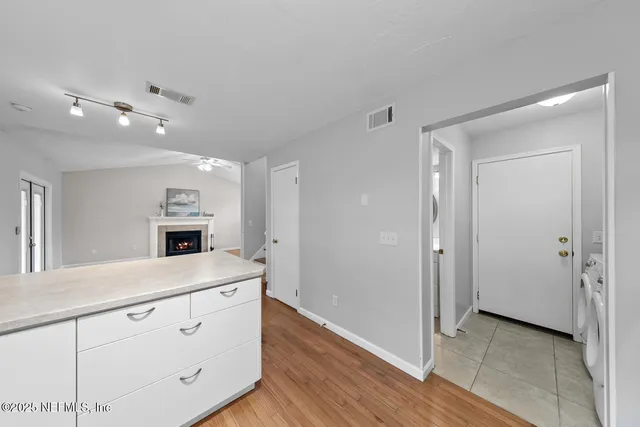 a view of a room with wooden floor and windows