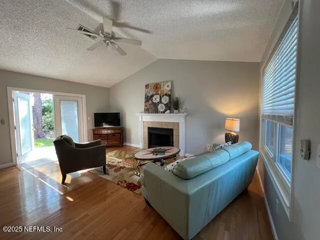 a living room with furniture a fireplace and a flat screen tv