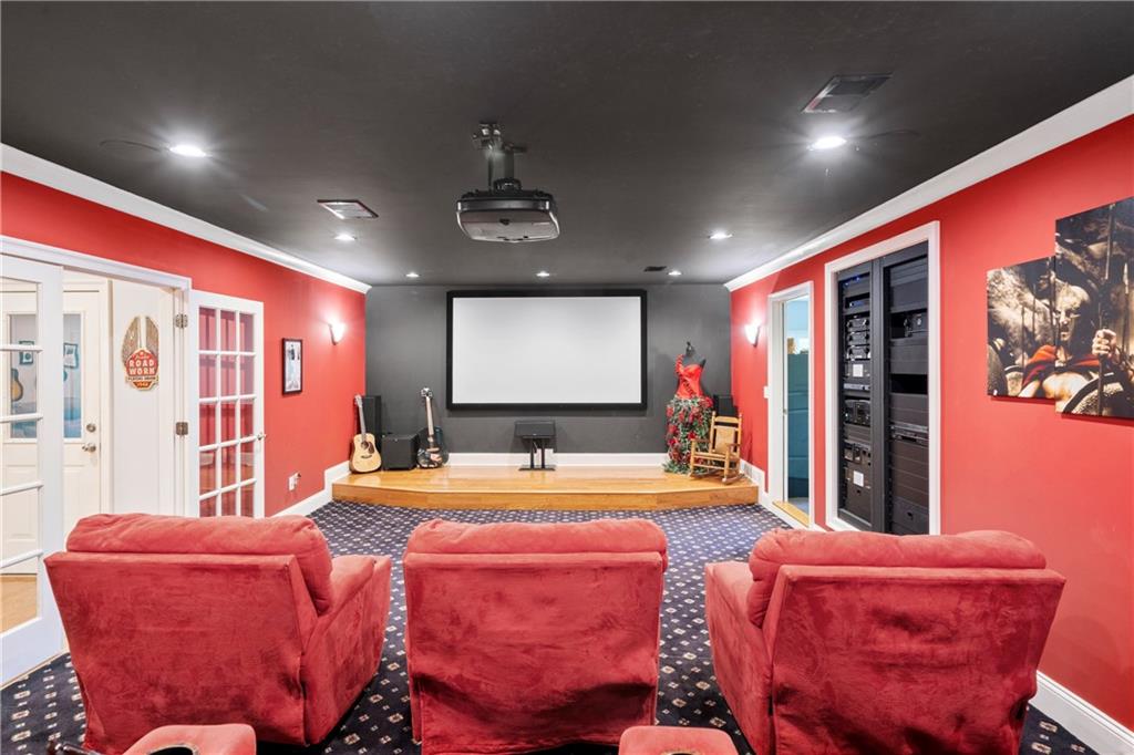 11 York Trace Southeast Cartersville, GA 30121 - Photo 7 of 71 a living room with furniture a projector and screen