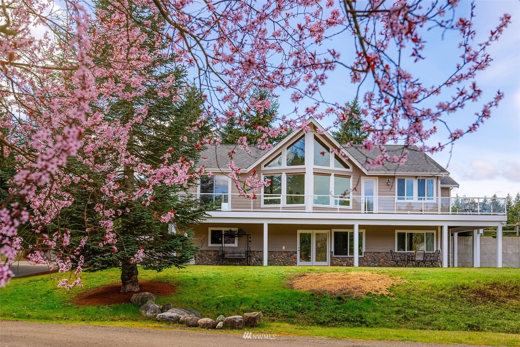 1579 Southwest J H Road Port Orchard, WA 98367 - Photo 1 of 36 a front view of a house with a yard and trees