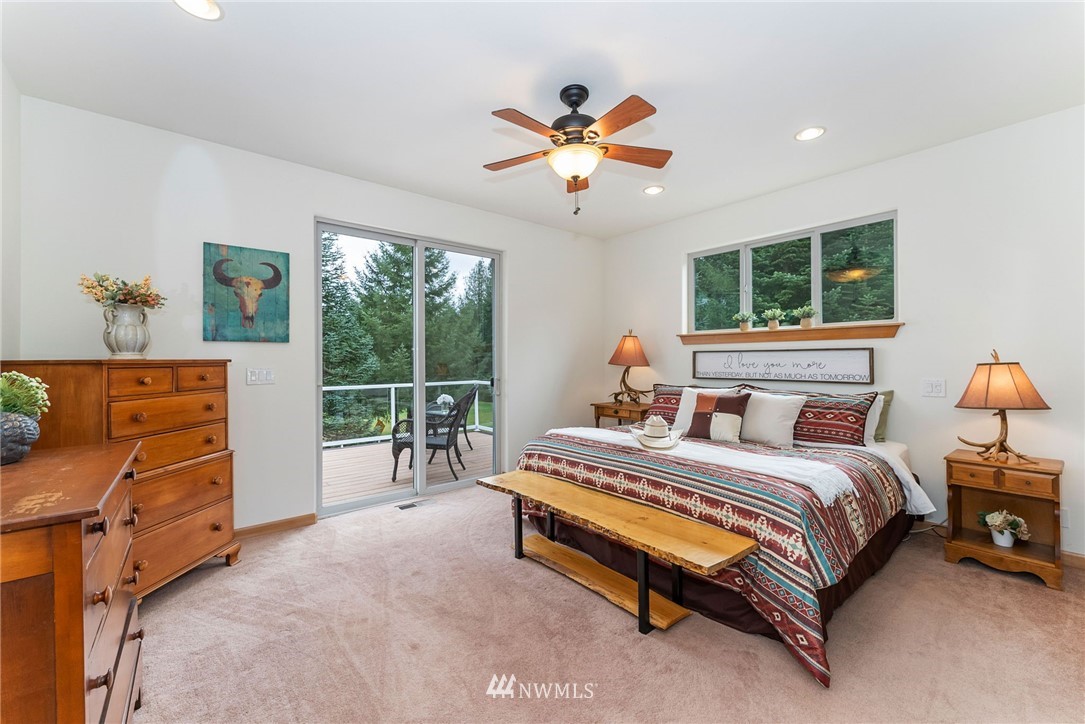 1579 Southwest J H Road Port Orchard, WA 98367 - Photo 13 of 36 a bedroom with a bed and a chandelier