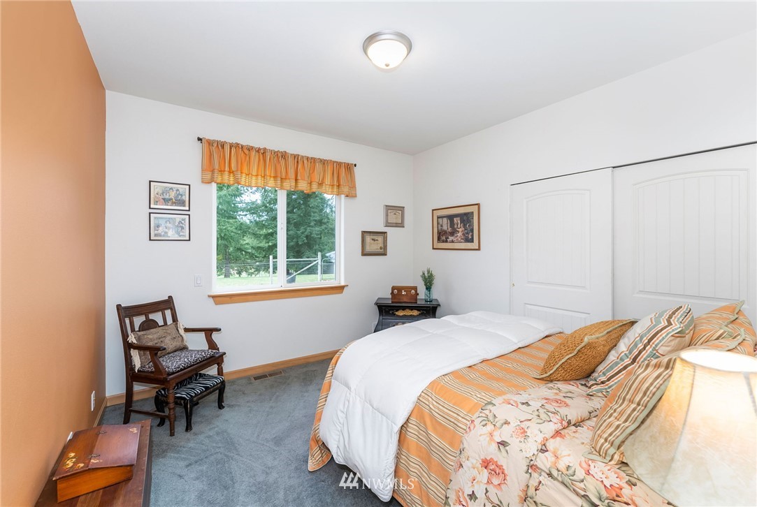1579 Southwest J H Road Port Orchard, WA 98367 - Photo 16 of 36 a bedroom with a bed and a window