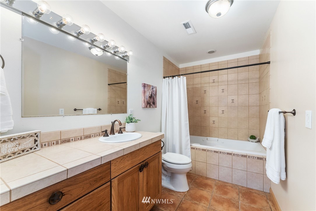 1579 Southwest J H Road Port Orchard, WA 98367 - Photo 21 of 36 a bathroom with a sink a toilet and shower