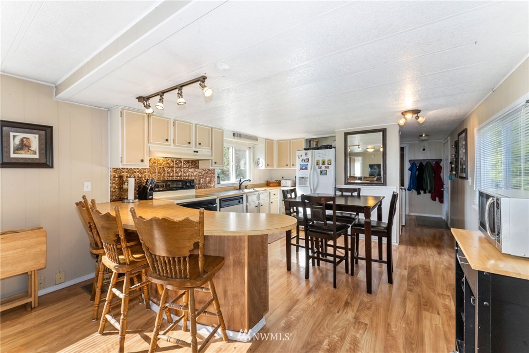 1579 Southwest J H Road Port Orchard, WA 98367 - Photo 23 of 36 a view of a dining room with furniture and wooden floor