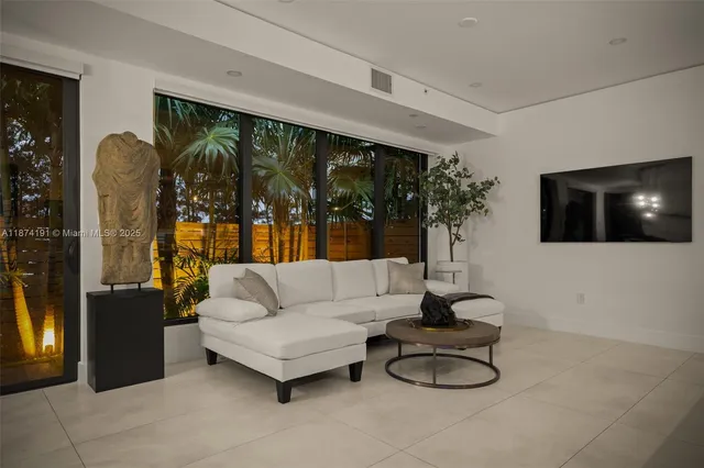a living room with fireplace furniture and a flat screen tv