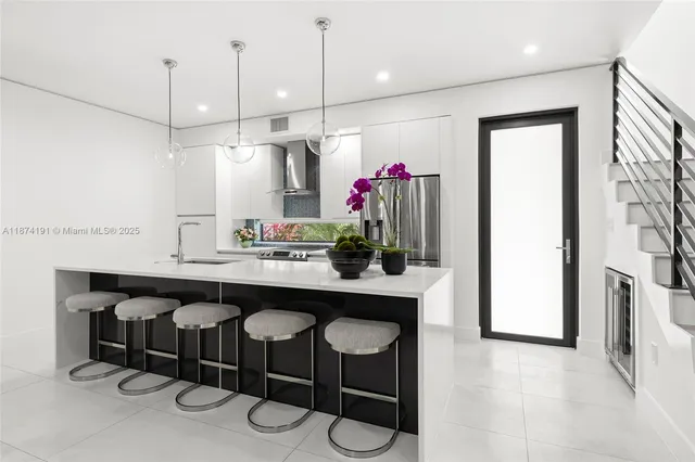 a kitchen with granite countertop a table and chairs in it