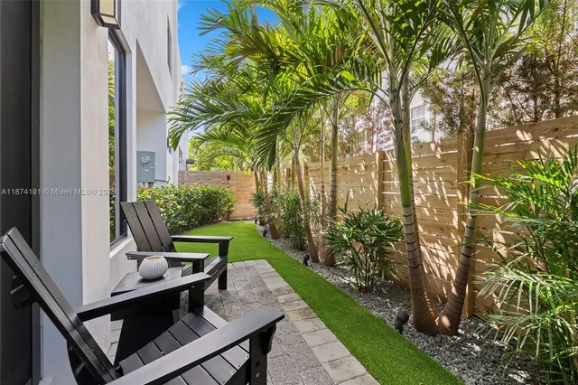 a view of a house with backyard and sitting area