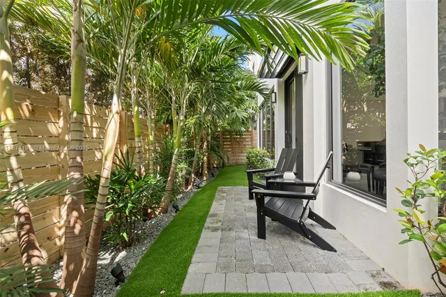 a view of a patio with a table and chairs