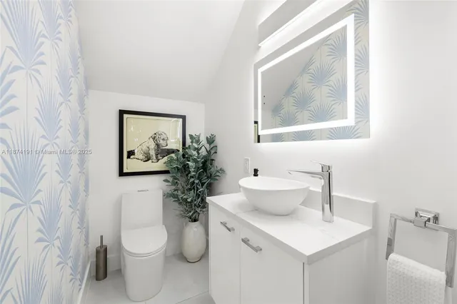 a bathroom with a toilet a sink and a mirror