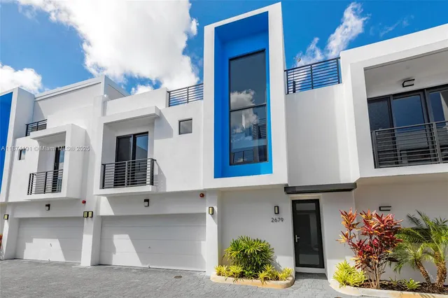 a front view of a house with a yard and flowers