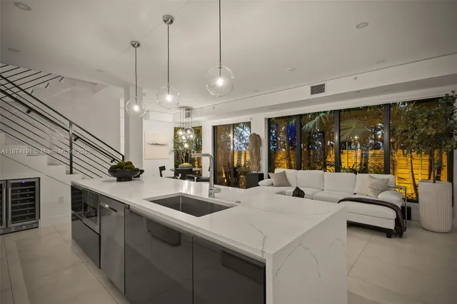 a large white kitchen with a large window