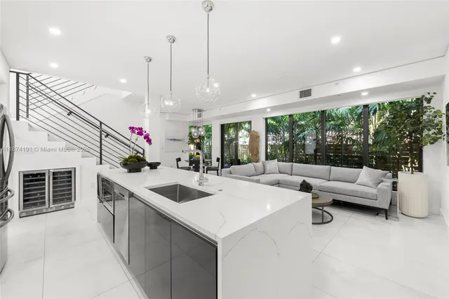 a kitchen with counter top space and living room